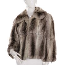 A chinchilla fur jacket, featuring a wide collar, hook and eye clip fastenings, leather bow