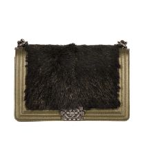 Chanel, a New Medium Boy bag, featuring a black faux fur front panel and gold leather trim, with a
