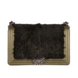 Chanel, a New Medium Boy bag, featuring a black faux fur front panel and gold leather trim, with a