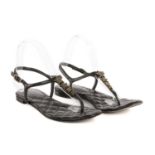Chanel, a pair of star thong sandals, crafted from black leather, featuring CC star embellishments
