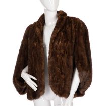 A ranch mink cape shrug, featuring a short lapel collar, cape sleeves, an open front, and an inner