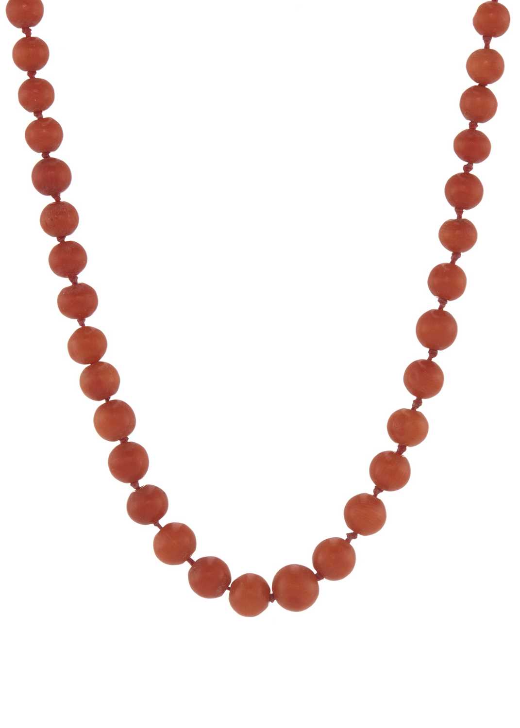 An early 20th century coral single-strand necklace, with gold clasp