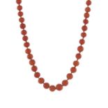 An early 20th century coral single-strand necklace, with gold clasp