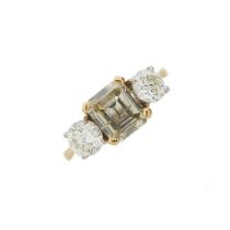 An 18ct gold coloured diamond and diamond three-stone ring