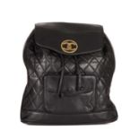 Chanel, a vintage black quilted leather backpack w/pouch, featuring gold-tone hardware, a front