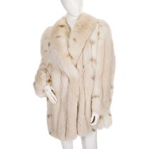 Saga, a fox fur coat with lynx effect tipped fur, featuring a lapel collar, hook and eye clip