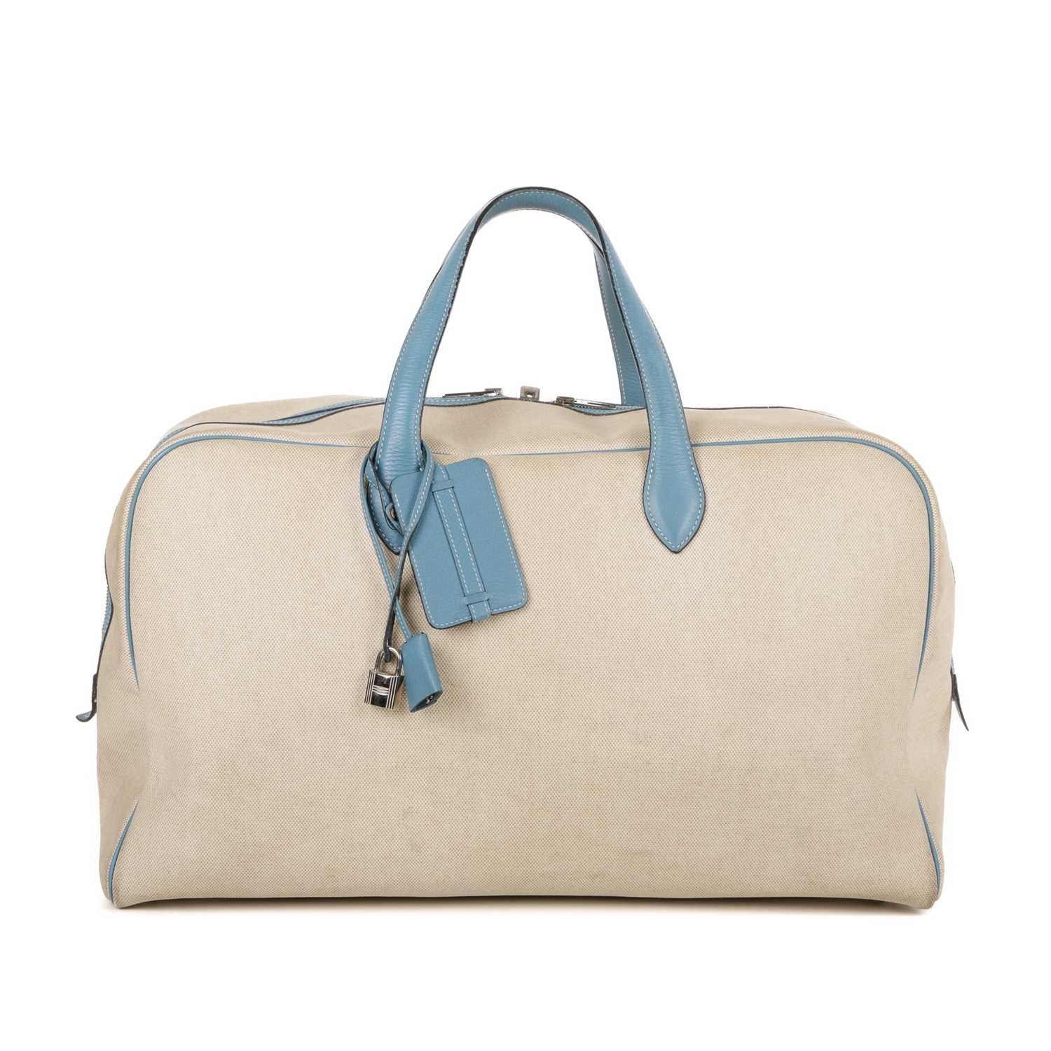Hermes, a 2000 toile Victora GM 50 travel bag, crafted from beige toile canvas with blue leather