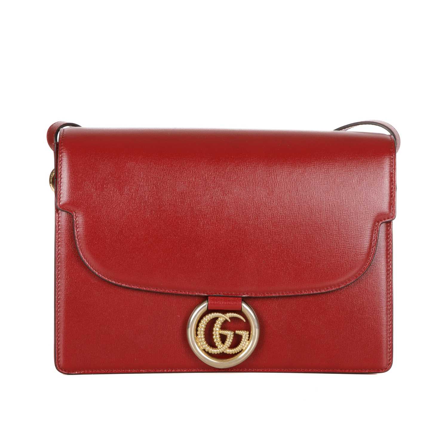 Gucci, a red leather satchel, featuring an adjustable leather shoulder strap, magnetic flap