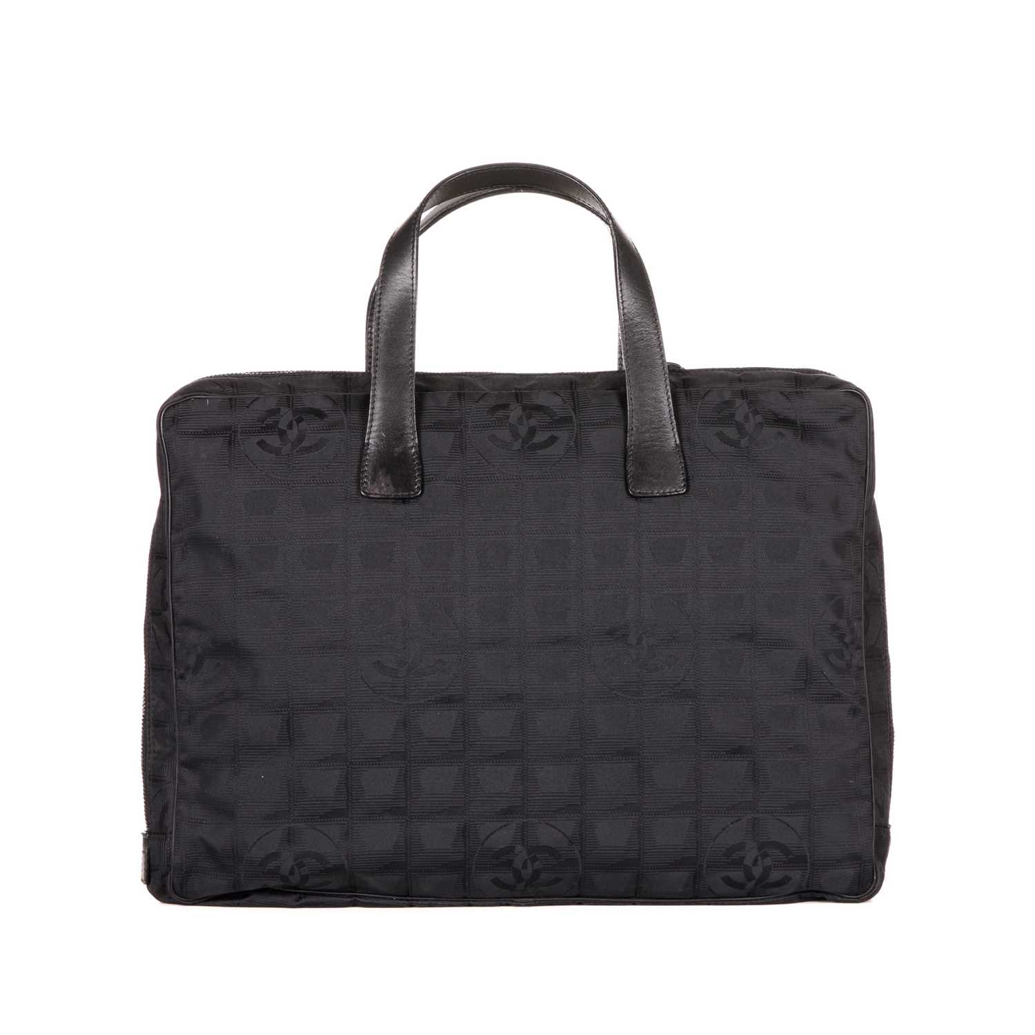 Chanel, a Travel Line briefcase, featuring a black nylon exterior, with flat black leather
