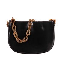 By Far, a black patent leather handbag, featuring an oversized chain-link shoulder strap, and a
