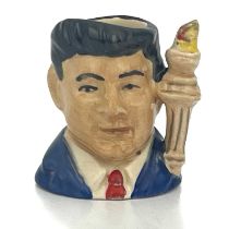 A Royal Doulton Tiny character jug, John F Kennedy, red tie and blue jacket, printed mark, 4cm high