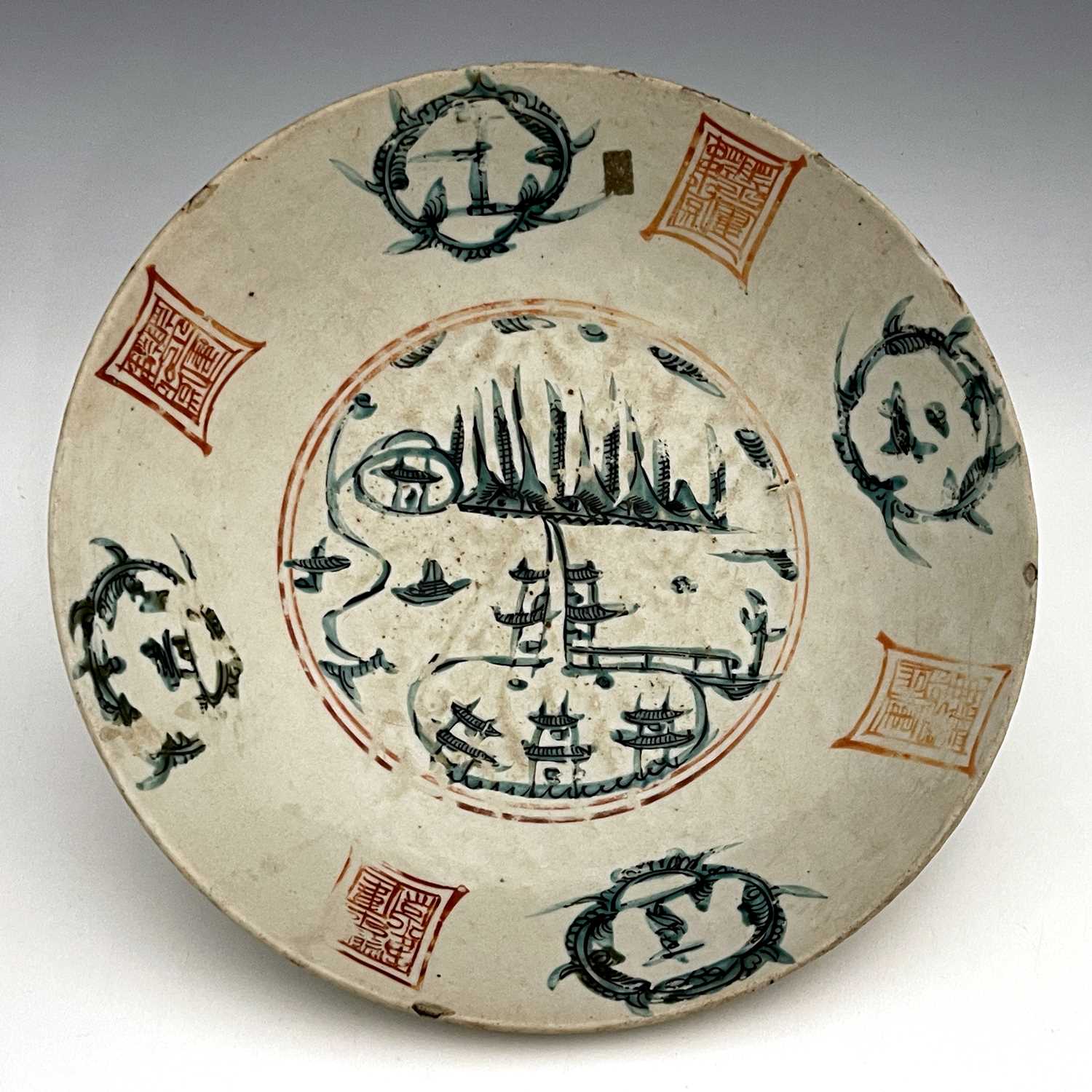 A Chinese famille verte dish, Ming, circular form, painted with a central landscape within an iron