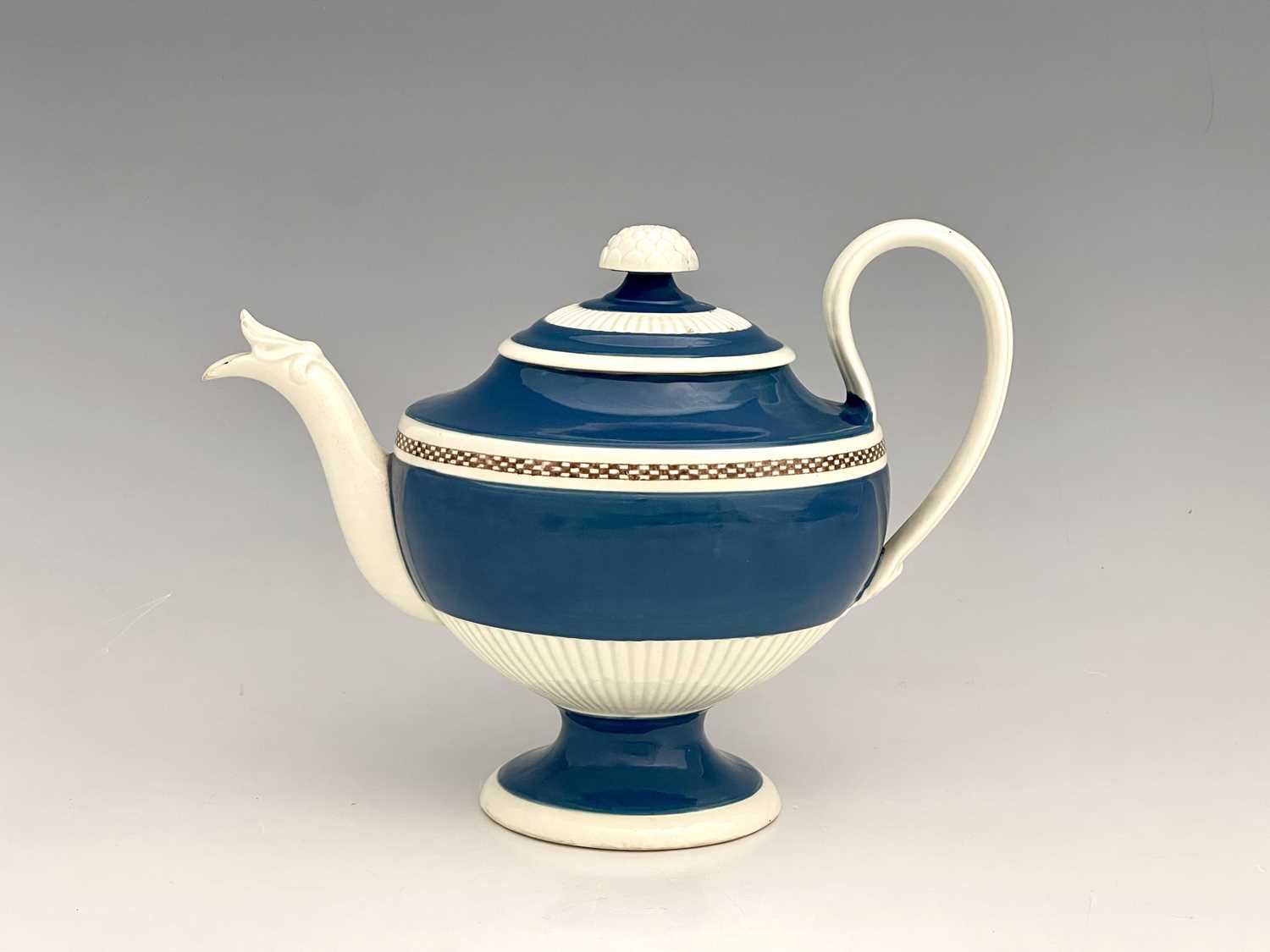 A Leeds pearlware Mocha teapot and cover, circa 1780, pedestal squat urn form, half reeded and