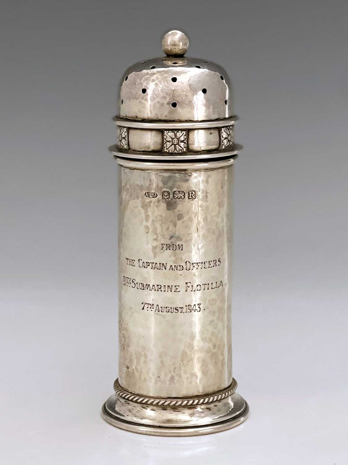 A E Jones, an Arts and Crafts silver shaker, Birmingham 1941, planished tubular turret form with