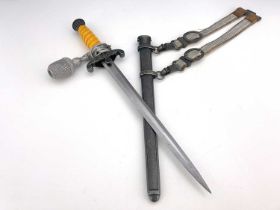 A German Third Reich Army Officer's dagger, ribbed orange plastic grip, eagle crossguard, metal