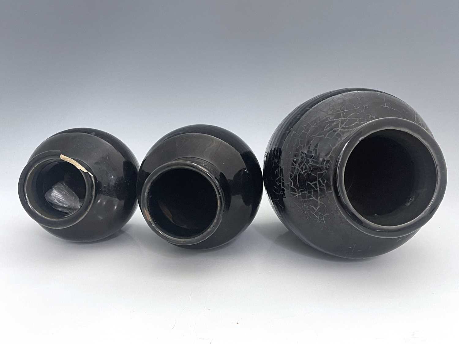 Three Chinese monochrome glazed vases, Qing Dynasty, shouldered ovoid form, black glazed, of varying