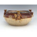 A Doulton Lambeth stoneware three handled sprigged bowl, salt glazed squat ovoid form, applied
