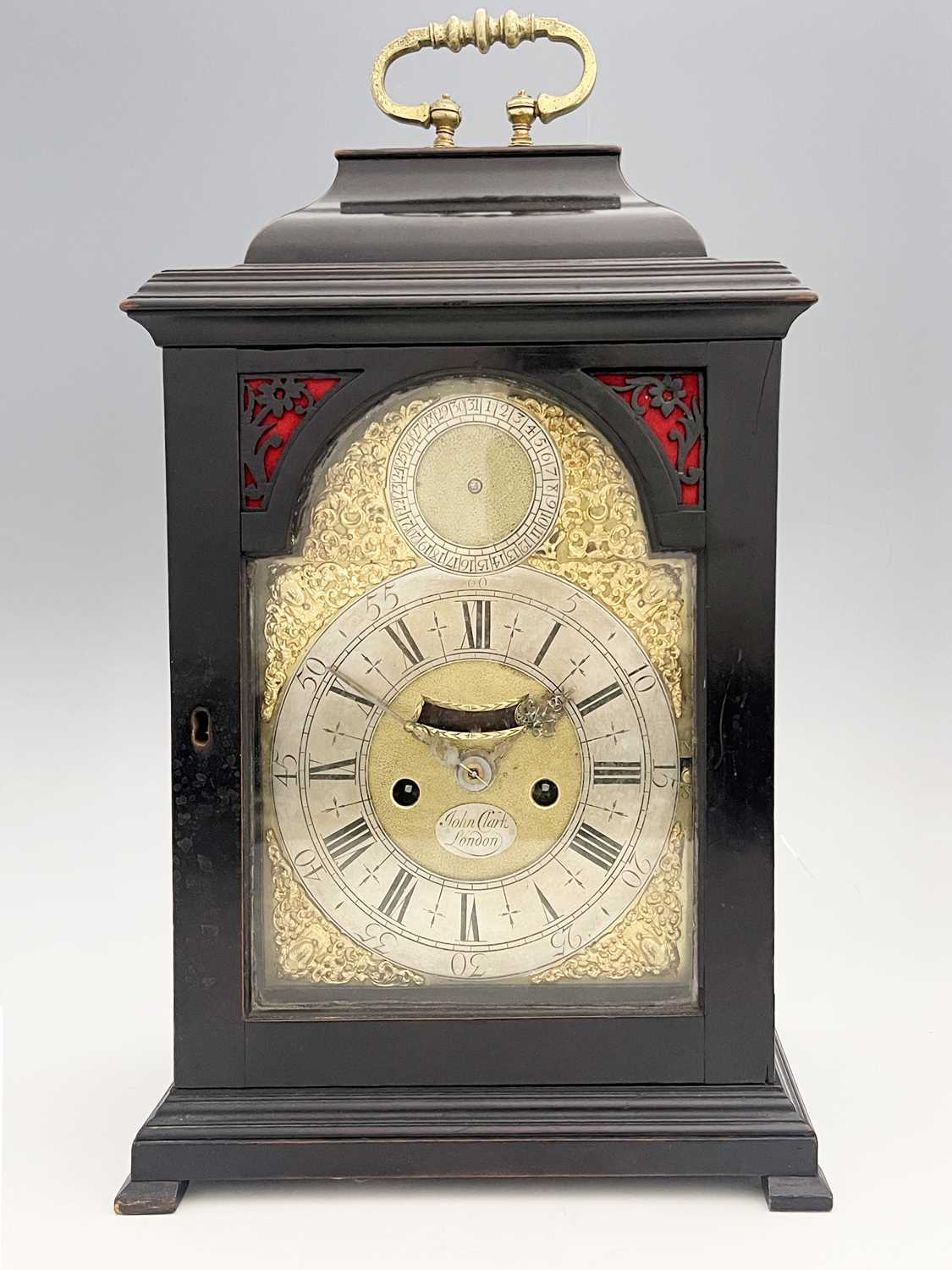 John Clark, London, a George II ebonised bracket clock, caddy top with a brass swing handle,