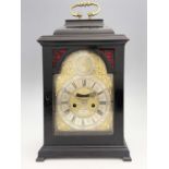 John Clark, London, a George II ebonised bracket clock, caddy top with a brass swing handle,