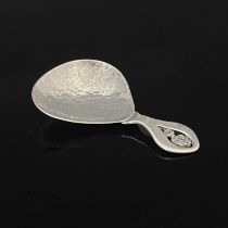 An Arts and Crafts silver caddy spoon, Winifred King and Co., Birmingham 1932, planished pear shaped