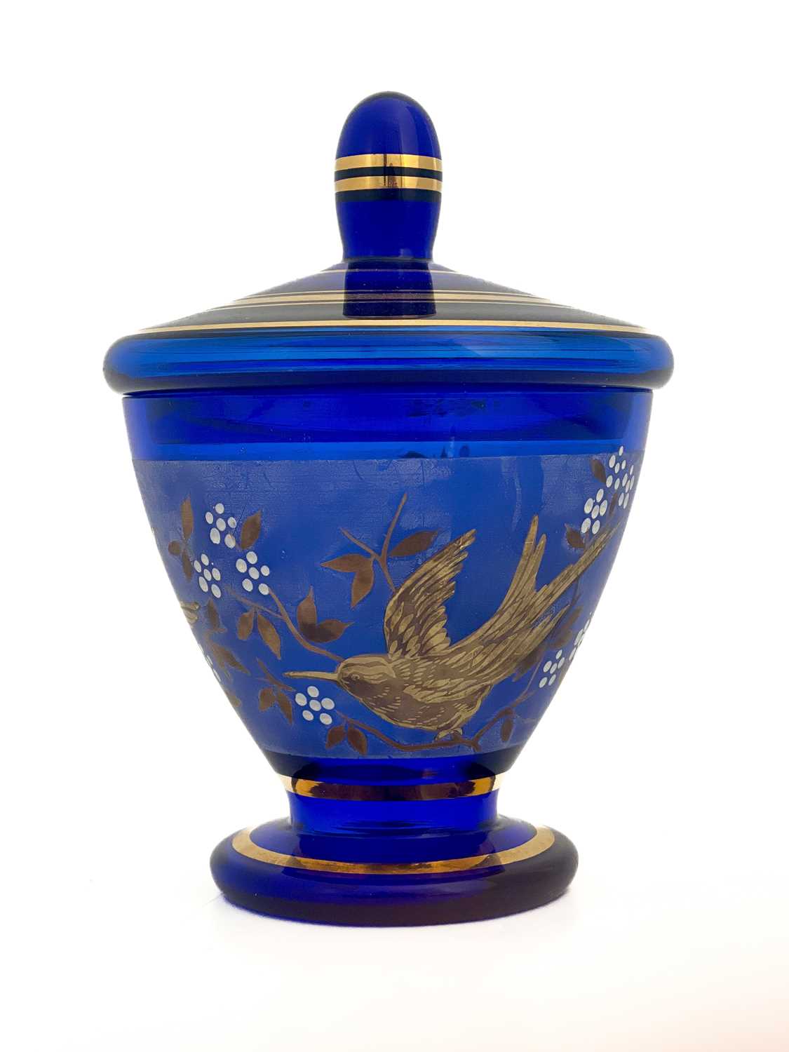A Bohemian tooled gilt and enamelled blue glass vase and cover, circa 1940s, footed form decorated
