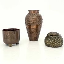Three Arts and Crafts copper vessels, including a Newlyn style vase embossed with panels of fish