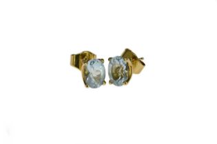 A pair of 18 carat gold and blue topaz earrings, oval single stones, 3.2g