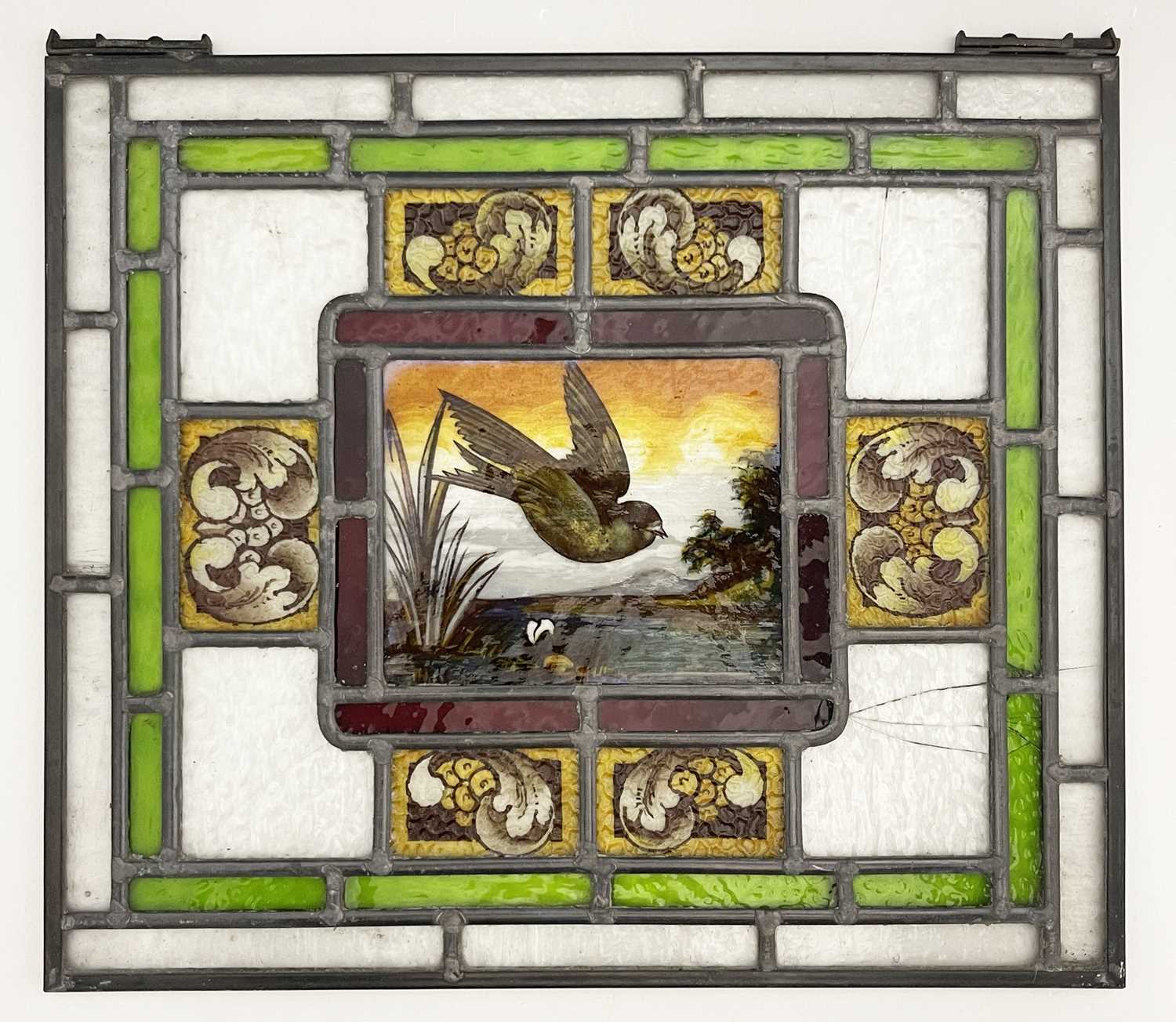 Two Aesthetic Movement leaded glass panels, painted with birds in flight over wetlands, within