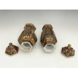 A matched pair of Chinese reticulated vases and covers, hexagonal section inverse baluster form,
