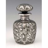 An American Art Nouveau silver overlay glass perfume bottle and stopper, ovoid form, chased with
