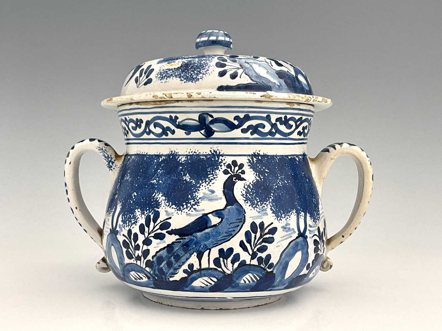 A William and Mary Bristol Delft posset pot and cover, circa 1690, twin handled squat baluster form,