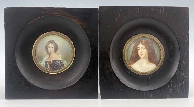 A pair of 19th-century portrait miniatures, finely painted to depict young women, one in the pre-
