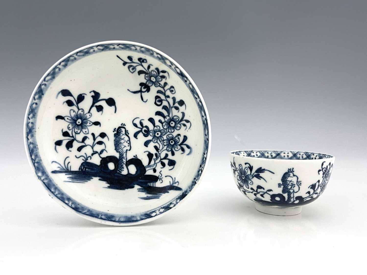 A Lowestoft blue and white tea bowl and saucer, circa 1770, painted in the Scholars Rock and