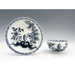 A Lowestoft blue and white tea bowl and saucer, circa 1770, painted in the Scholars Rock and