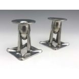 Archibald Knox for Liberty and Co., a pair of Tudric Arts and Crafts pewter candlesticks, model