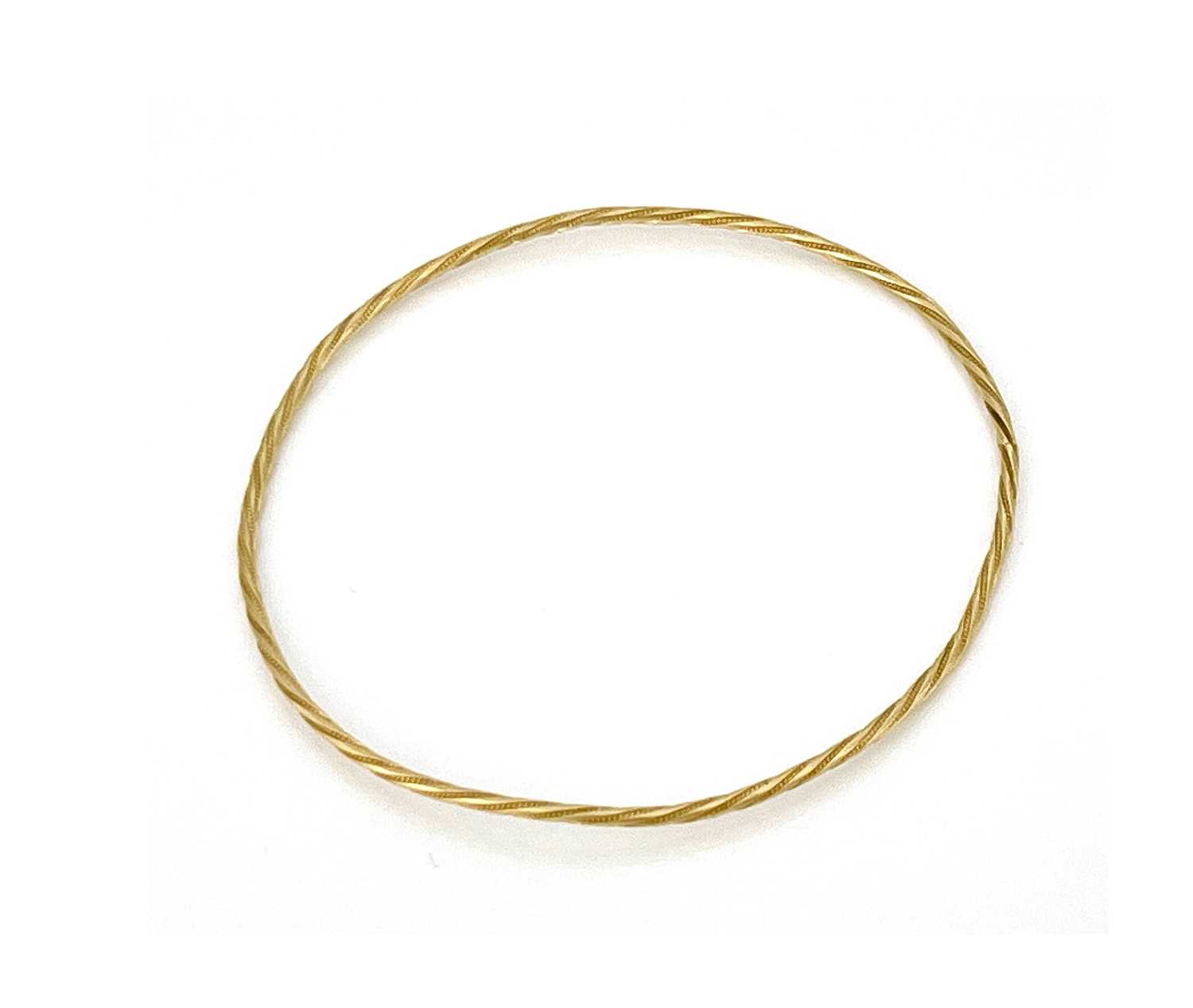 A Yellow metal bangle bracelet, twisted wire form, 7cm diameter, 4.4g