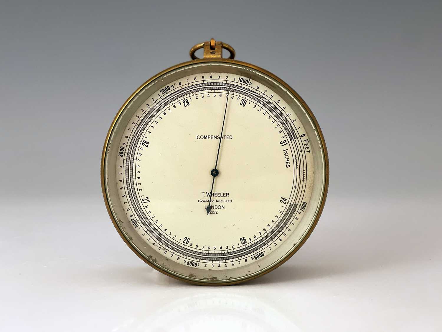 T. Wheeler, London, an early 20th Century Compensated brass military marine barometer, silvered
