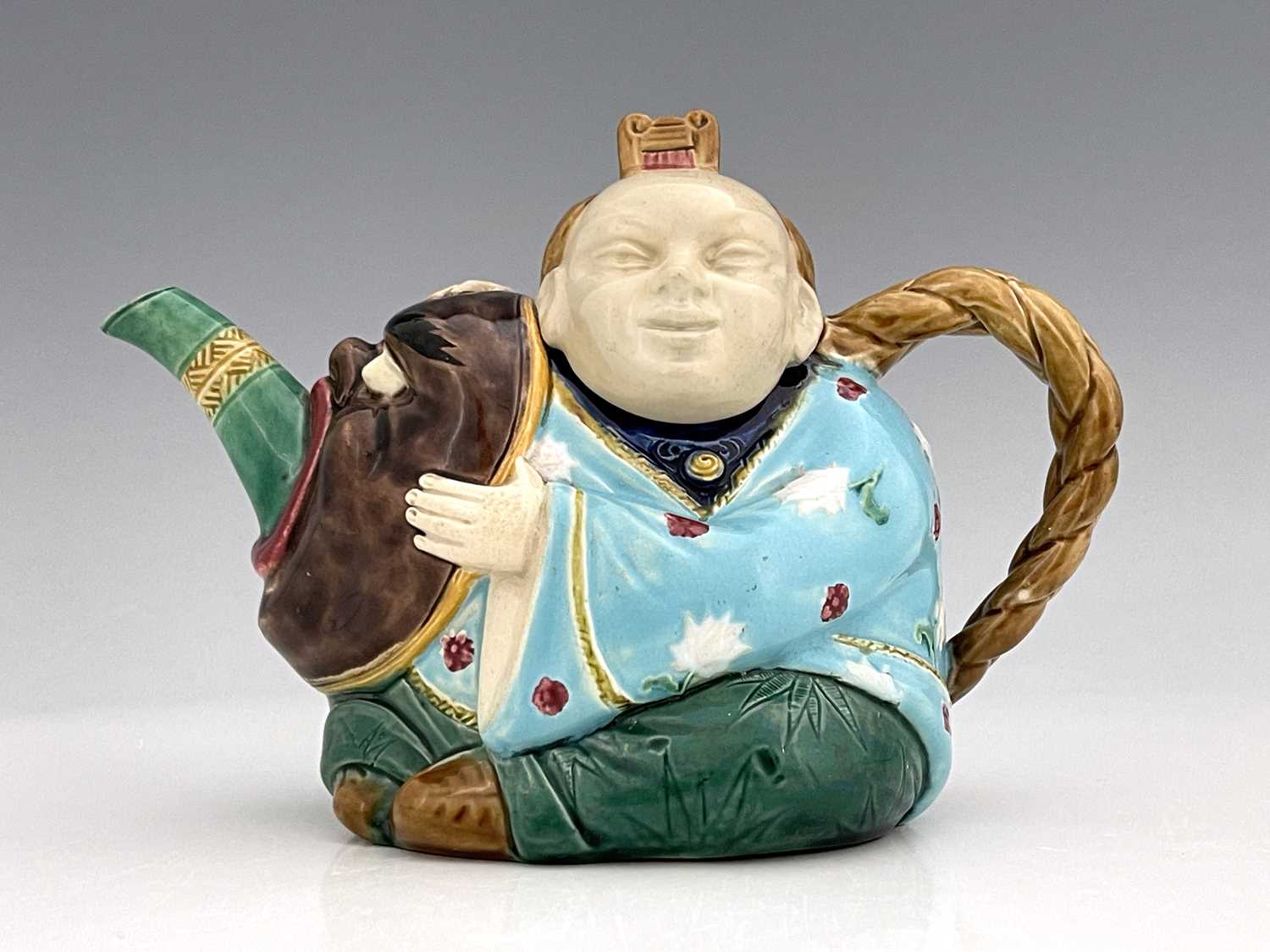 A Minton majolica Aesthetic Movement Chinaman teapot, circa 1860s, modelled in relief with turquoise