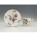 A Meissen floral painted cup and saucer, rattan moulded borders, decorated with floral bouquets