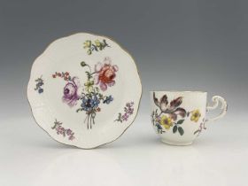 A Meissen floral painted cup and saucer, rattan moulded borders, decorated with floral bouquets