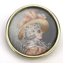 An antique circular portrait brooch, 18th Century lady in profile wearing a hat with pink