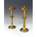Vanpoulle of Westminster, a pair of Gothic Revival brass candlesticks, cylindrical sconces,