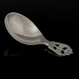Sidney Reeve, an Arts and Crafts silver caddy spoon, Birmingham 1935, the planished oval bowl on a