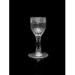 A facet stem wine glass, circa 1775, the rounded bowl engraved with a band of fruiting vines and