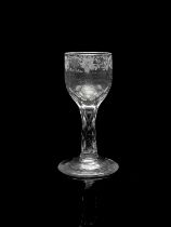 A facet stem wine glass, circa 1775, the rounded bowl engraved with a band of fruiting vines and