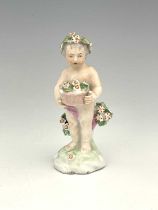 A Derby porcelain figure of a putto, circa 1765, modelled holding a floral basket, standing