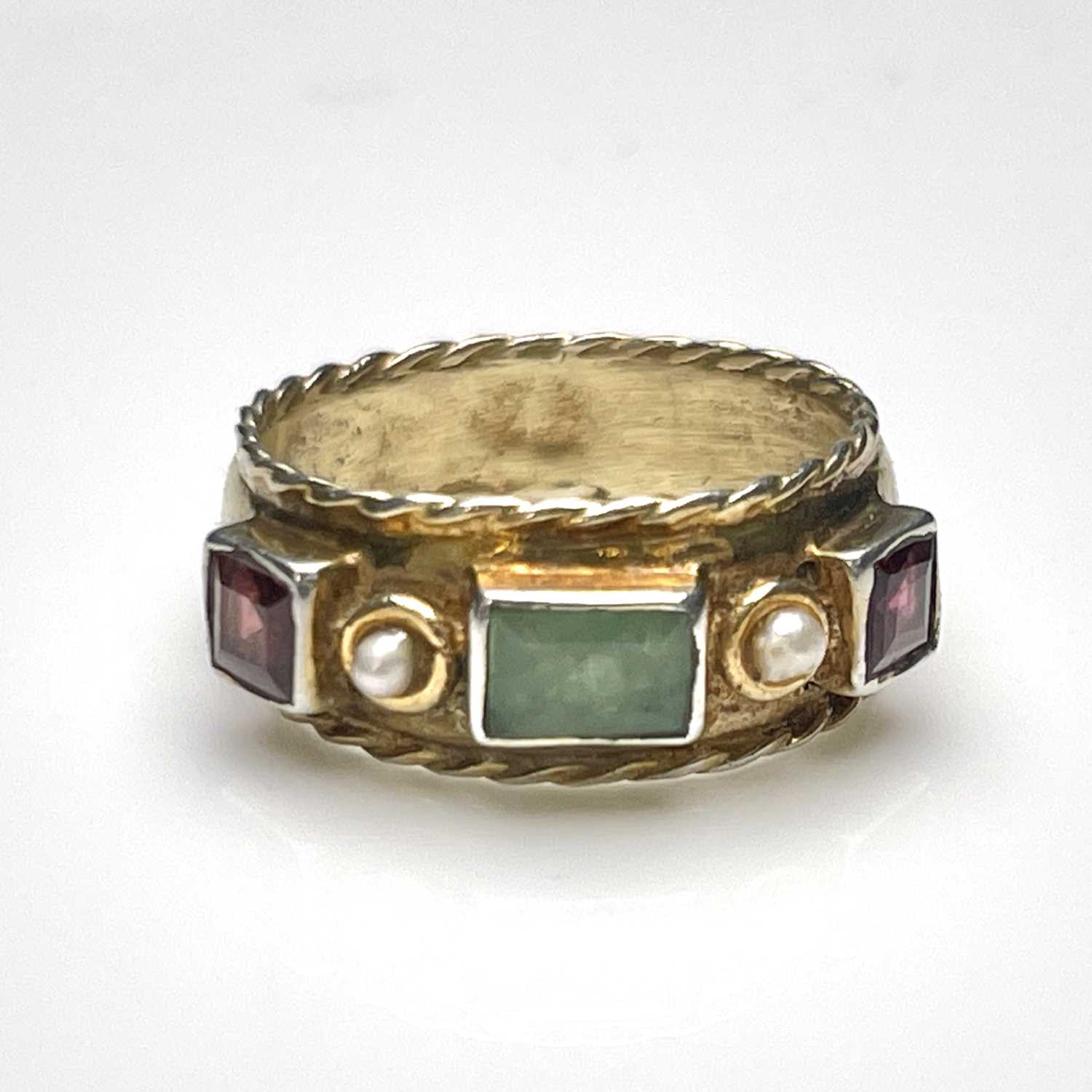 A Byzantine Revival silver gilt and gem set ring, the band with ropetwist borders, set with a
