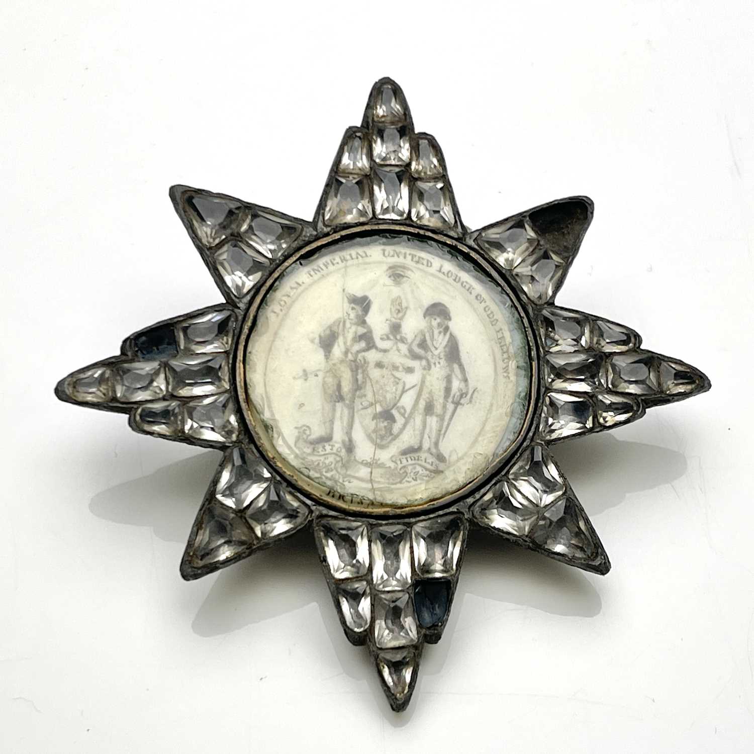 Masonic interest, a George III paste star badge, the central vellum roundel painted with the arms of