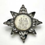 Masonic interest, a George III paste star badge, the central vellum roundel painted with the arms of