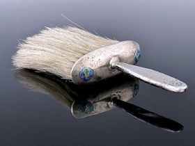 Jessie M King for Liberty and Co., an Arts and Crafts silver and enamelled crumb brush, Birmingham